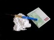 Injection on cocaine drug powder and hundred euro banknote on black background