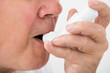 © Andrey Popov - Man Using Asthma Inhaler