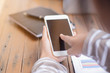 © stcom - Young businesswoman hard at work at her desk writing notes on a