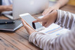 © stcom - Young businesswoman hard at work at her desk writing notes on a