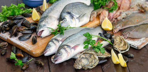 Wall Mural - Raw seafood on wooden board.