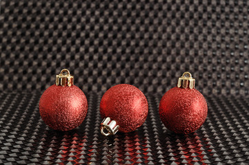 red christmas tree baubles isolated on a black background