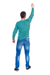 Wall Mural - back view of writing business man. Rear view people collection.  backside view of person. Isolated over white background. A man in a green jacket and jeans marker writing on the wall above his head.