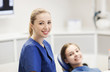 © Syda Productions - happy female dentist with patient girl at clinic