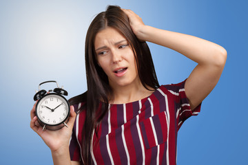 Wall Mural - Young woman showing alarm clock