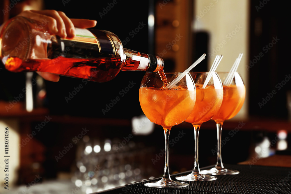 Woman hands making cocktail on bar counter