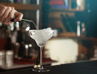 Poster - Woman hands making cocktail on bar counter