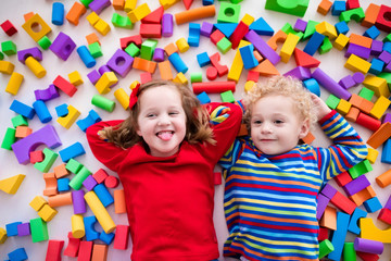 Wall Mural - Children playing with colorful blocks.