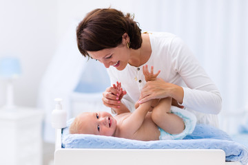 Wall Mural - Mother and baby on changing table