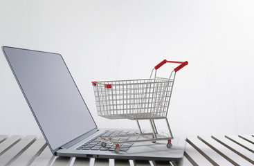 Wall Mural - online shopping concept with 3d rendering shopping cart on keyboard