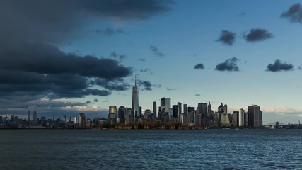 Fototapete - New York City Lower Manhattan cityscape time lapse video with afternoon rain storm. View of  Financial District skyscrapers, Midtown West and Ellis Island