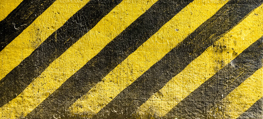 striped black and yellow background. Industrial striped road warning yellow-black pattern. Caution sign on the street, warning and dangerous.
