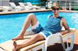© Viacheslav Yakobchuk - Handsome joyful man lying on the sun bed