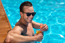 Delighted Man Resting In The Swimming Pool