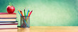 © Romolo Tavani - Apple On Stack Of Books With Pencils And Blank Chalkboard - Back To School