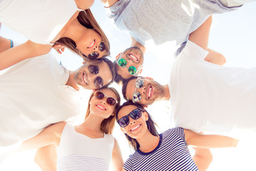 Sticker - friendly group of six students laugh and look down at camera on