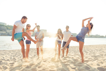 Canvas Print - trendy joyful girlfriends with boyfriends relaxing on beach at s