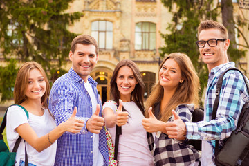 Canvas Print - diverse five joyful friends showing thumbs up standing near camp