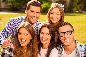 Poster - cheerful five friends hug and rest at sunny day