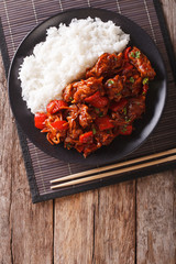 Wall Mural - Chinese food: pork in sweet and sour sauce with rice close-up. Vertical top view
