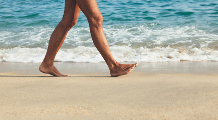 Close-up of man's feet at the shore
