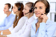 © rogerphoto - Young beautiful business woman in headset. Call center operator.