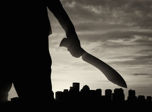 Silhouette Of Man Holding Knife