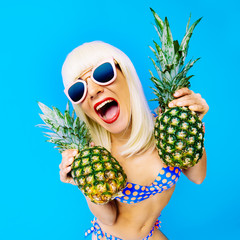 Crazy Party time. Sexy Blonde with pineapple on a blue backgroun