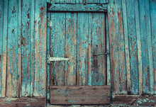 Old, Abandoned, Wooden, Painted In Blue, Cracked, Rotten Door With A Hook From The Hut