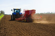 © Connect Images - Farm tractor and seed drill sowing ploughed field in spring
