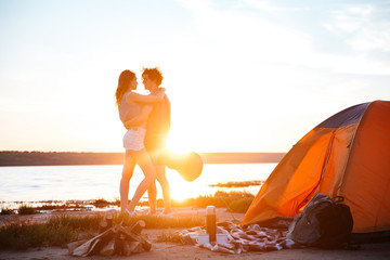 Poster - Portrait of a happy young couple hugging at the seaside