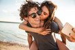 © Drobot Dean - Young happy couple kissing and making selfie at the beach