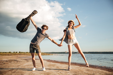 Wall Mural - Portrait of a young couple having fun on the beach