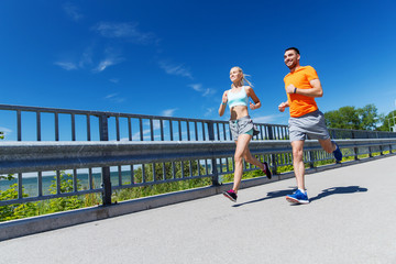 Wall Mural - smiling couple running at summer seaside