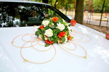 Stunning bouquet made of white and orange roses put over white c