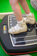 child feet on a vibrating training platform