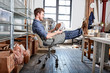 © Connect Images - Man sitting at table in pottery workshop