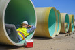 © Bryan Hainer/Blend Images - Caucasian construction worker napping inside large pipe