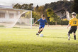 © Sollina Images/Blend Images - Boys playing soccer on field
