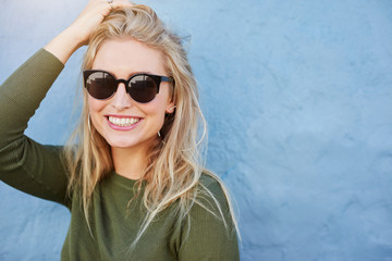 Pretty young woman in sunglasses smiling