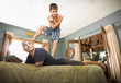 © Sollina Images/Blend Images - Boy standing on father on bed