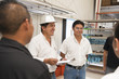 © Sollina Images/Blend Images - Workers talking in manufacturing plant