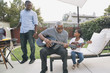 © Hello Lovely/Blend Images - African American grandfather teaching granddaughter to play guitar