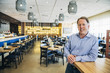 © Inti St Clair/Blend Images - Smiling Caucasian man leaning on counter at restaurant