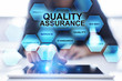 © WrightStudio - Woman using tablet pc and pressing 'Quality assurance' on virtual screen.