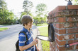 © Kevin Dodge/Blend Images - Caucasian boy opening mailbox