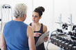 © Marc Romanelli/Blend Images - Older Hispanic man working with trainer in gym