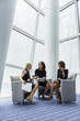 © Mark Edward Atkinson/Tracey Lee/Blend Images - Businesswomen sitting in armchairs talking