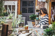 © Inti St Clair/Blend Images - Mixed race employee using laptop in plant nursery