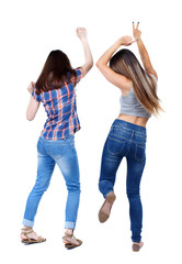 Back view of two dancing young women. Dance party. girls teens dance, enjoy and express positive emotions and having fun. backside view of person.  Rear view people collection. Isolated over white